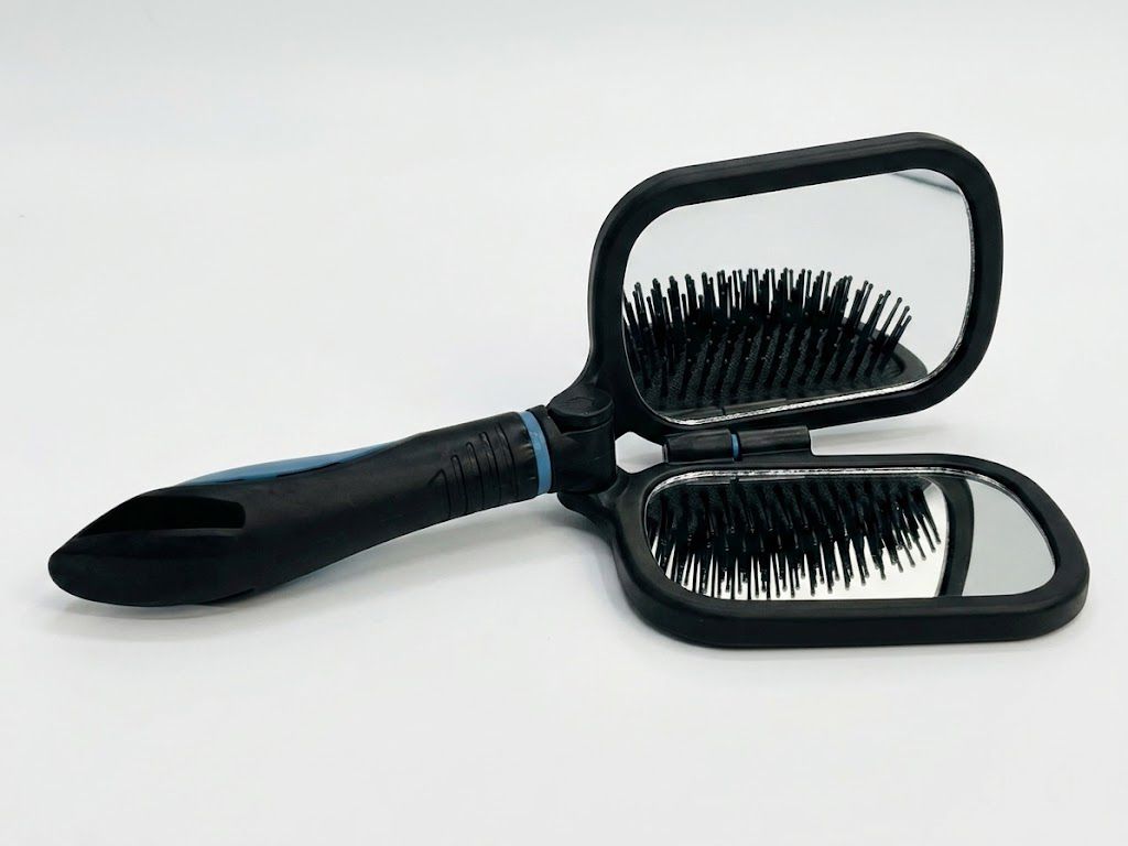 Cepillo cabello espejo integrado abierto mostrando ambas funciones cerdas y espejo Click & Go